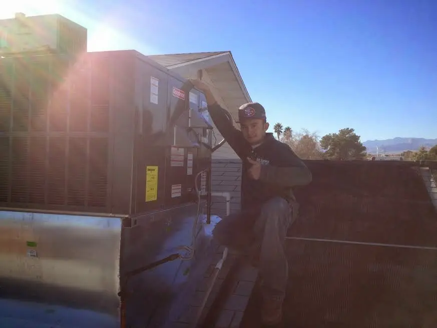 HVAC technician performing Air Duct Repair on a rooftop unit in Lake Mary